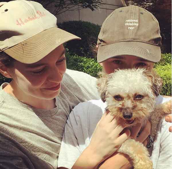 Emma Portner and Ellen Page pose with their cute puppy.